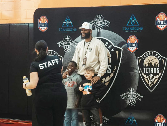image of tampa bay titans representative taking a picture with two young fans