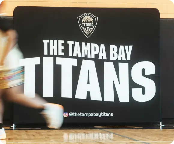 image of a banner in a basketball court with "Tampa Bay titans" and logo
