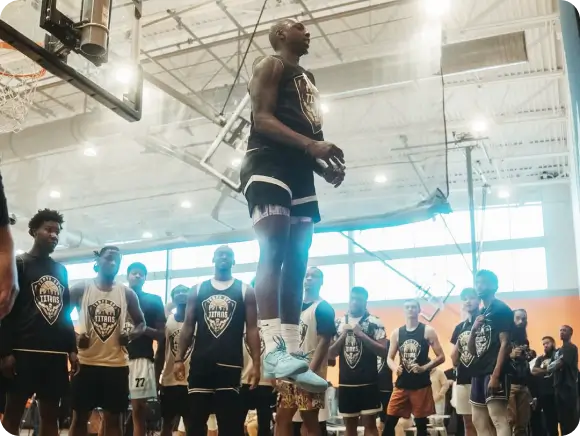 image of a basketball player jumping with other watching him